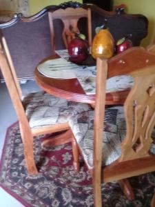a table and two chairs with apples on it at Josan's Haven in Ocho Rios