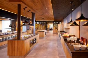 a large kitchen with a buffet line in a restaurant at LUNARIS Wellnessresort in Cadipietra