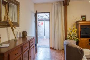 a living room with a large mirror and a television at PINAR DE LAS CABAÑUELAS in Villanueva de Duero