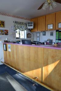 a kitchen with a counter with a laptop on it at Silver Maple Inn and The Cain House Country Suites in Bridgeport