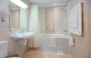 a bathroom with a sink and a tub and a shower at Karlovo Hotel in Sunny Beach