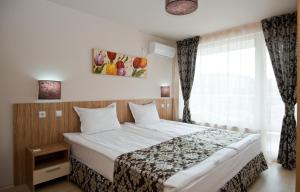 a bedroom with a bed and a window at Karlovo Hotel in Sunny Beach