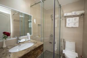 a bathroom with a toilet and a sink and a shower at Park Hill Hotel - Phu My Hung in Ho Chi Minh City +41 photos