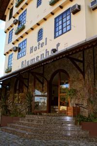 a hotel entrance with stairs in front of it at Hotel Blumenhof in Blumenau