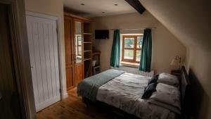 A bed or beds in a room at The Pebley Inn