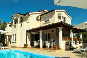 a house with a swimming pool in front of it at Villa Zare in Poreč