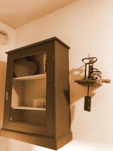 a wooden cabinet with a cat sitting on a shelf at Les Chalets du Galibier II in Valloire