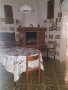 a living room with a table and a fireplace at A casa di nonna Vituccia, nel cuore del Salento! in Neviano