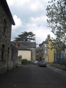 a street in a town with cars parked on the road at The Old Masonic Lodge in Shepton Mallet