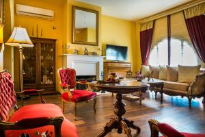 a living room with a couch and a table and chairs at Palazzino Di Nionio in Karavádhos