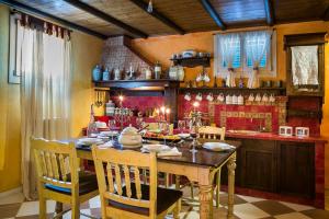 a dining room with a wooden table and chairs at Palazzino Di Nionio in Karavadhos