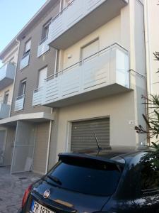 a car parked in front of a building at NUOVO BILOCALE IN VIA LAGOMAGGIO, 31 in Rimini