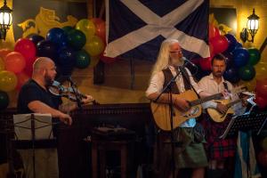 a group of men playing instruments with balloons at The Forth Inn in Aberfoyle