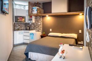 a bedroom with a bed and a table with a toy horse on it at Darwin Apart Hotel in Salta