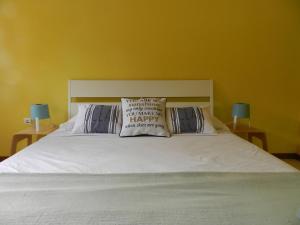 a white bed with two pillows on top of it at La Residencia in Mindelo