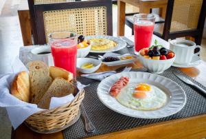 a breakfast table with eggs and bread and drinks at Casa Pizarro Hotel Boutique in Cartagena de Indias