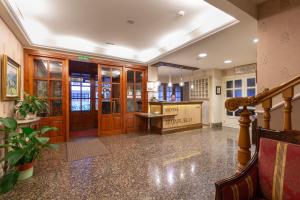 a large lobby with wooden doors and a counter at Hotel Bujaruelo in Torla-Ordesa