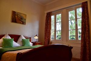 a bedroom with a bed and a large window at Hotel Athos in Baden-Baden