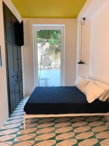 a bedroom with a bed and a view of a pool at PrimoPianoPosillipo in Naples