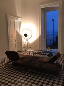 a living room with a couch and a table at PrimoPianoPosillipo in Naples