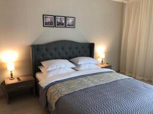 a bedroom with a large bed with two lamps at Сонячне Закарпаття in Polyana