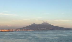 a mountain in the distance with a body of water at PrimoPianoPosillipo in Naples