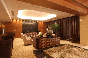 
a living room filled with furniture and a large window at Geosciences International Conference Centre Hotel in Beijing
