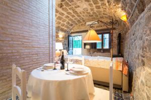 a table and chairs in a room with a mirror at Villa Amalia Suites Malaga in Málaga