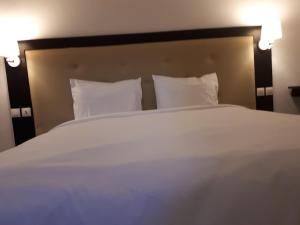 
A bed or beds in a room at hôtel sainte emmanuelle
