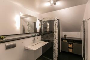 a bathroom with a sink and a mirror at FaroeGuide in Tórshavn