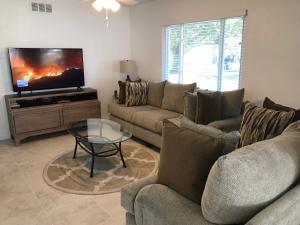 a living room with a couch and a tv at Pine Street in Clearwater