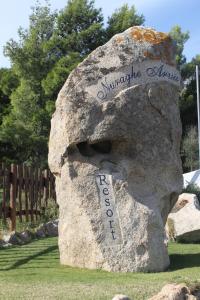 a rock with a head on top of it at Hotel Resort Nuraghe Arvu in Cala Gonone