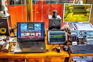 a desk with a laptop computer and other electronics on it at Cabañas Malleo in Junín de los Andes
