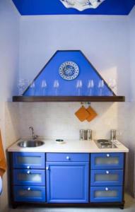 a bathroom with a blue sink and a plate on the wall at La Mattanza in Trapani