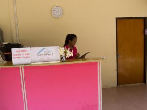 a woman sitting at a counter with a laptop at Gypsy Village 2 in Phi Phi Islands