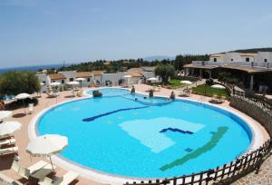 an overhead view of a large swimming pool at a resort at Hotel Resort Nuraghe Arvu in Cala Gonone