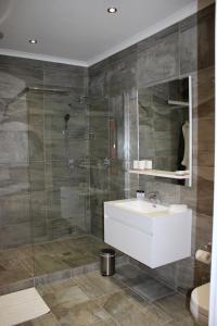 a bathroom with a sink and a shower at Somerset Hill in Somerset West