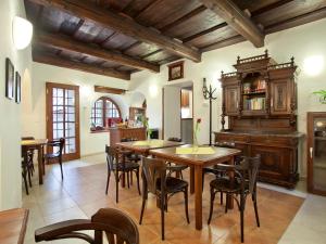a kitchen and dining room with wooden tables and chairs at Staroměstský Penzion in Tábor