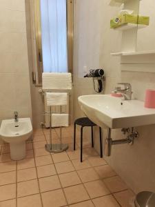 a white bathroom with a sink and a toilet at B&B Monté in Montesilvano