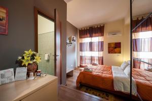 a bedroom with a bed and a bathroom with a mirror at Sky Sleeping in Palermo