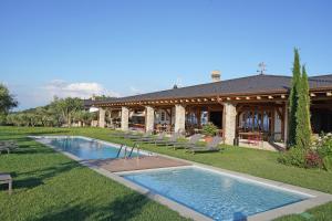 a house with a swimming pool in the yard at Pietra Cavalla - Ranch & Resort in Polpenazze del Garda