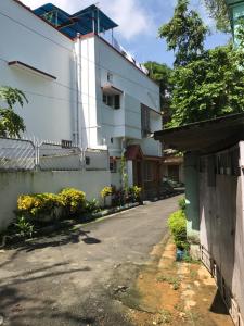 an empty street in front of a white building at Far From The Madding Crowd in Taliganja