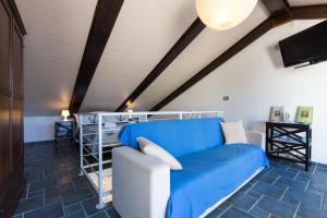 a living room with a blue couch and a tv at Apartments DDD in Baška