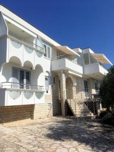 a large white building with a driveway in front of it at Galeb in Vodice