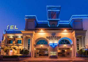 a building with a sign on the front of it at Natoli Motel in Tainan