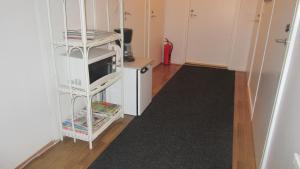 a room with a white shelf with a microwave at Ruska Bed & Breakfast in Taivalkoski