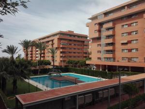 a swimming pool in front of two tall buildings at Apartamento Algazul in Almería