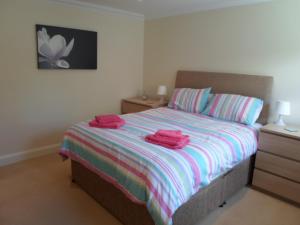 a bedroom with a bed with two towels on it at Viking Villa in Broadstairs