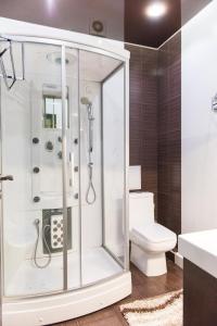 a bathroom with a shower and a toilet at Apartment on Kunayeva 38 in Shymkent +12 photos