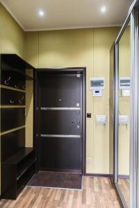 a closet with a black door in a room at Apartment on Kunayeva 38 in Shymkent